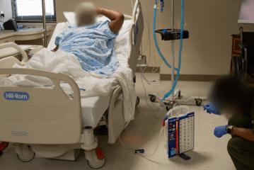 A gowned patient in a hospital bed