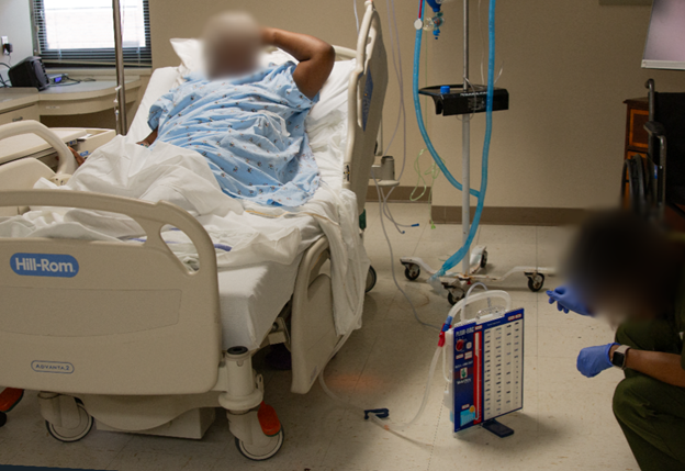 A gowned patient in a hospital bed