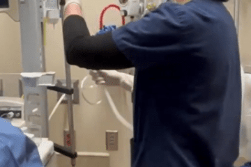 A nurse in navy blue scrubs preparing a chest tube
