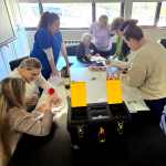 A group of health-care professionals participating in a tabletop health-care simulation
