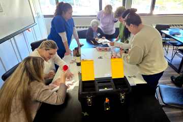 A group of health-care professionals participating in a tabletop health-care simulation