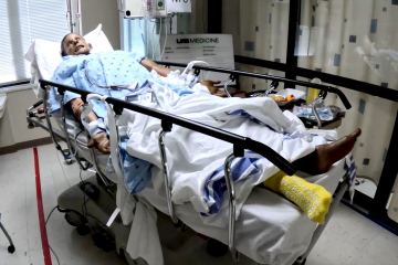 A health-care simulation manikin laying in a hospital bed