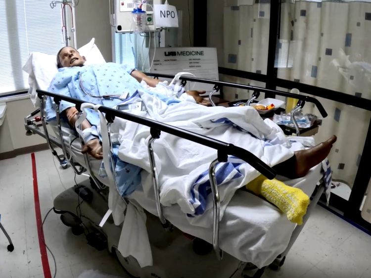 A health-care simulation manikin laying in a hospital bed